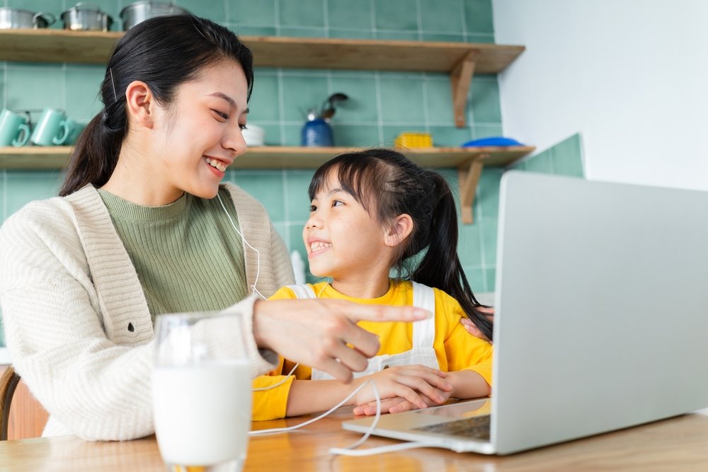 A parent and child enjoying a learning session together