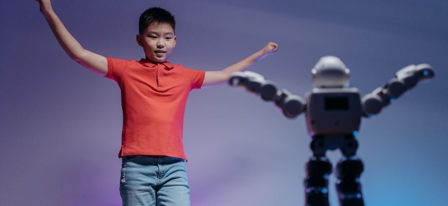 A student celebrating alongside a robot they built